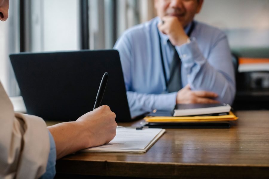 A candidate and a BringOffer consultant reviewing paperwork during a consultation